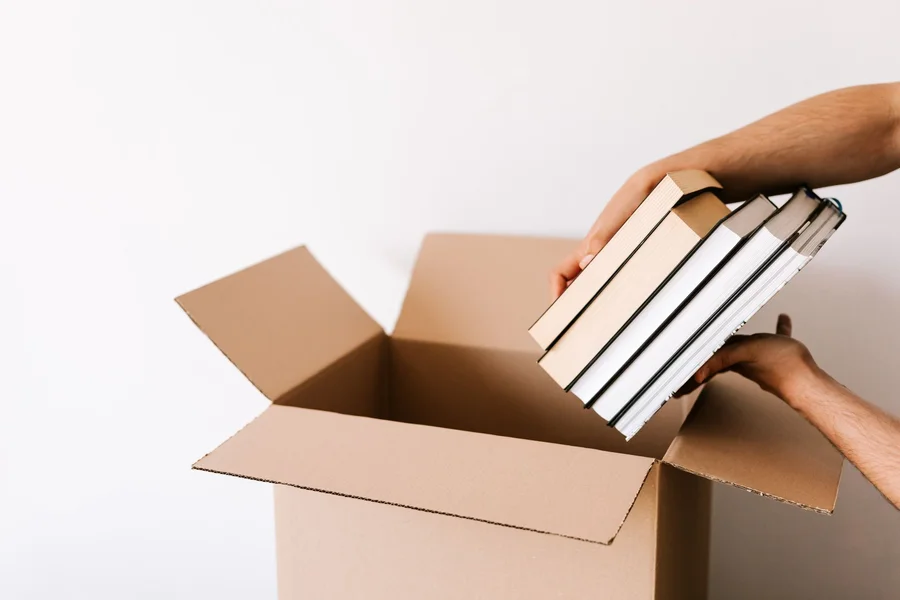 Packing books in a small cardboard box