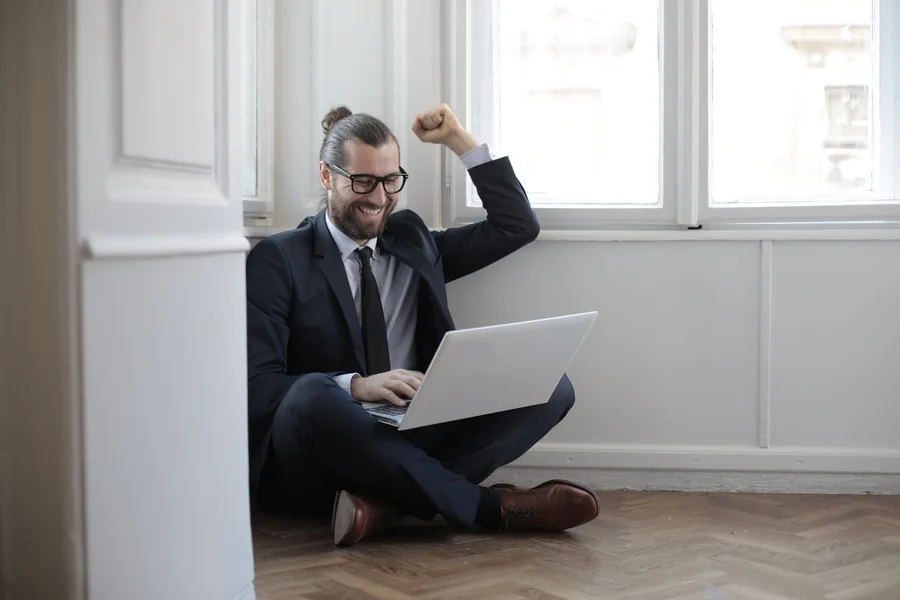 Person working while sitting on the floor with laptop