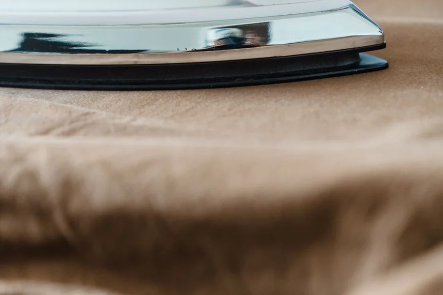 Understitching: How to Sew Flat Edges and Facings Ironing fabric steam close up