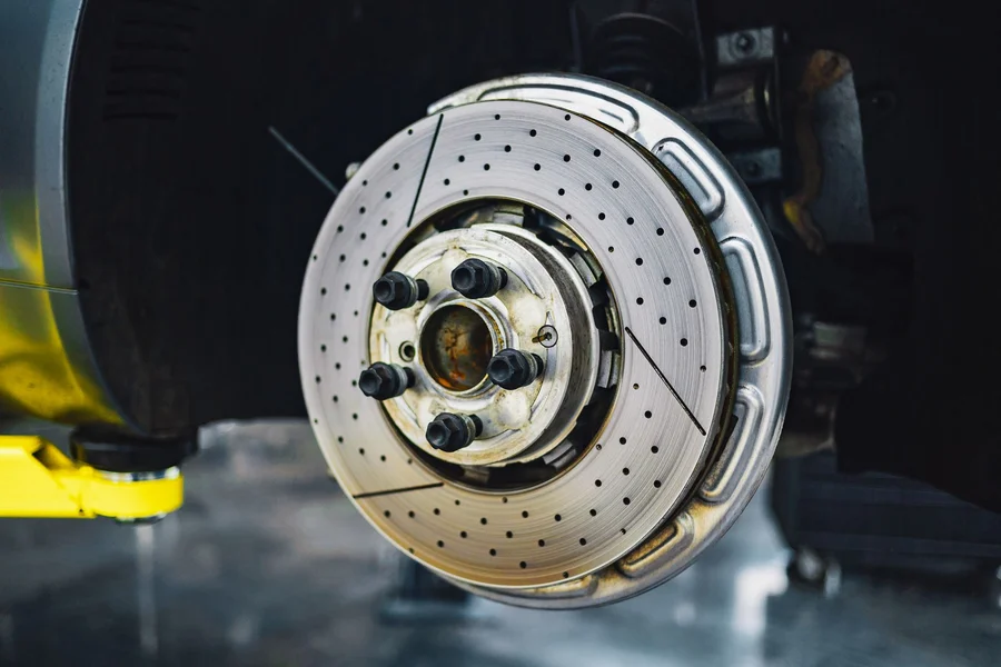 Chevy Hillsboro Oregon: Dealerships, Models & Service Guide Professional automotive mechanic inspecting vehicle brake and tire assembly