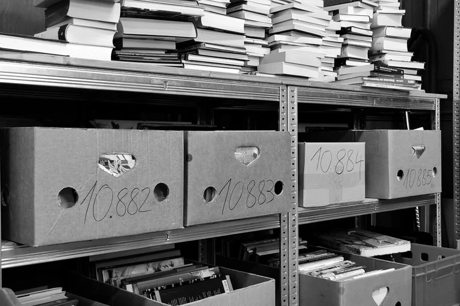 Stacked cardboard banker boxes holding archive paper records