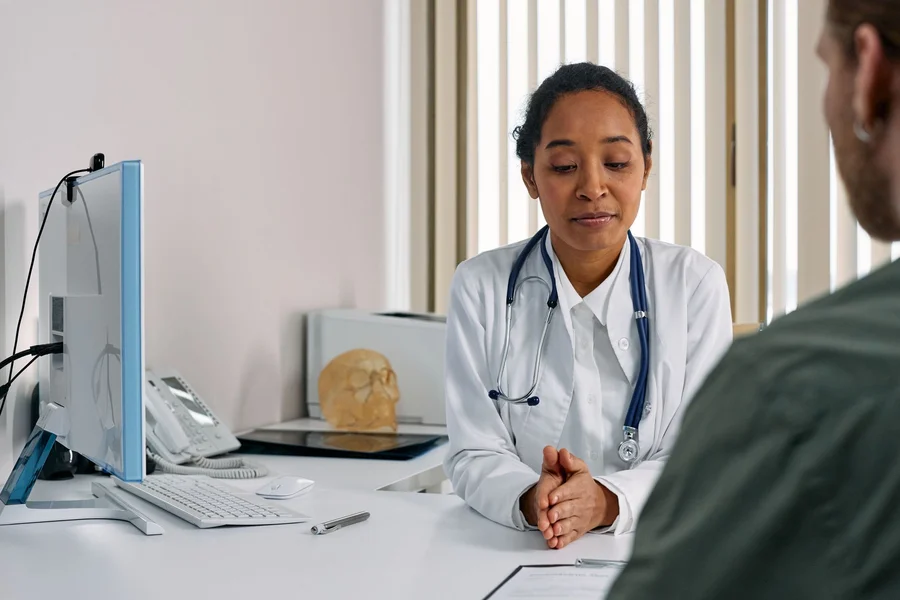 Medical professional discussing health topics with a patient in an office