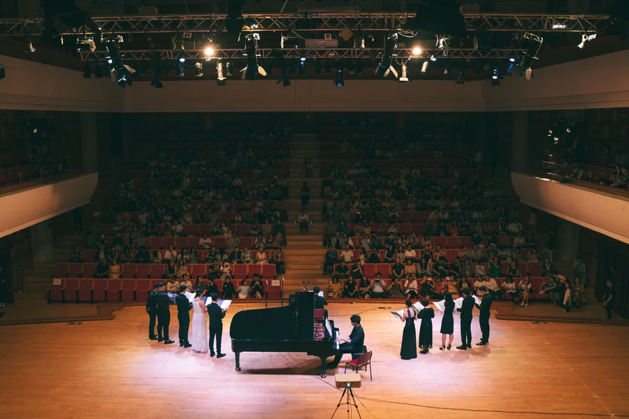 Mazowsze US Tour: Dates, Performers & Polish Folk Spectacle Full symphony orchestra and vocal choir performing in grand concert hall